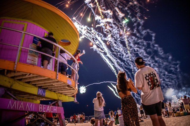 People watch the 4th of July fireworks show during Independence Day celebrations in Miami Beach, Florida, USA on July 4, 2023. The Fourth of July and Independence Day, have been a federal holiday in the United States since 1941, but the tradition of Independence Day celebrations dates back to the 18th century and to the American Revolution. (Photo by Cristóbal Herrera/EPA/EFE)