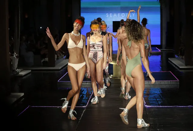 Models walk down the runway wearing Seafolly swimwear at a FUNKSHION fashion show during Swim Week, Sunday, July 23, 2017, in Miami Beach, Fla. (AP Photo/Lynne Sladky)