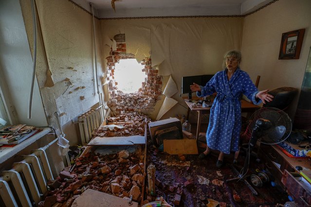 Local resident Viktoria Aksenova, 61, assesses the damage and removes debris inside her apartment hit by shelling in the course of Russia-Ukraine conflict in Donetsk, Russian-controlled Ukraine on August 23, 2023. (Photo by Alexander Ermochenko/Reuters)