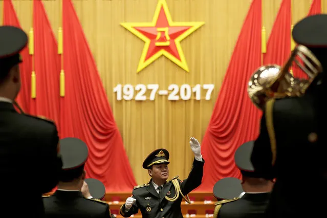 A military band conductor rehearses ahead a ceremony to commemorate the 90th anniversary of the founding of the People's Liberation Army at the Great Hall of the People in Beijing, Tuesday, August 1, 2017. China's President Xi Jinping has issued a tough line on national sovereignty amid multiple disputes with his country’s neighbors, saying China will never permit any loss of territory. Xi’s declaration came during a nearly one-hour speech Tuesday in Beijing marking the 90th anniversary of the founding of the People’s Liberation Army. (Photo by Andy Wong/AP Photo)