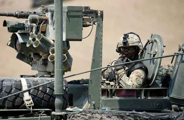 A US serviceman sits on M1126 Stryker Infantry Carrier Vehicle (ICV) during a closing ceremony of NATO-led joint military exercises Noble Partner 2017 at Vaziani Training Area outside Tbilisi, Georgia, August 12, 2017. (Photo by David Mdzinarishvili/Reuters)