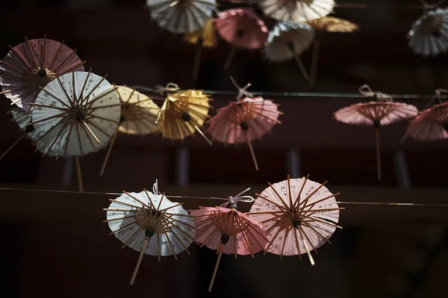 Kasa-mikuji or umbrella-shaped written oracles are hanged at Susanoo Shrine Saturday, June 3, 2017, in Tokyo. (Photo by Eugene Hoshiko/AP Photo)