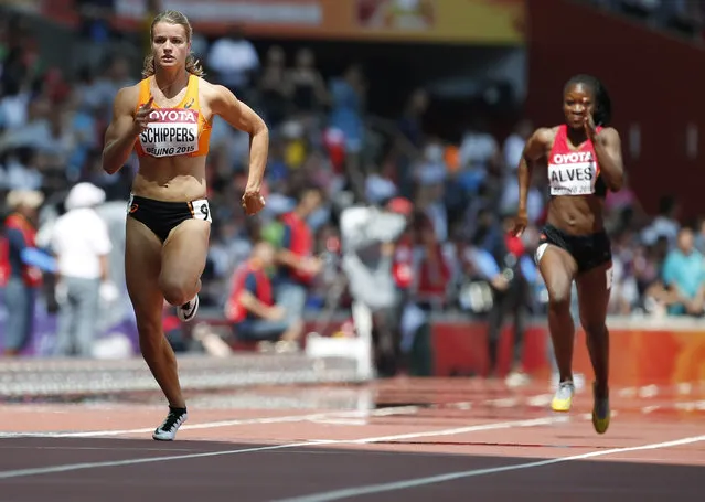 Dafne Schippers of the Netherlands (L) sprints ahead of Adriana Alves of Angola to win their women's 100 metres heat at the 15th IAAF World Championships at the National Stadium in Beijing, China August 23, 2015. (Photo by Lucy Nicholson/Reuters)