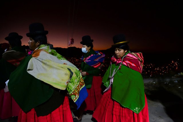 People gather to make an offering in honor of Pachamama, the goddess of earth and fertility, on Mother Earth Day, in El Alto, Bolivia, August 1, 2022. (Photo by Claudia Morales/Reuters)