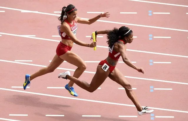 Jasmine Todd of the U.S. (R)  receives the baton from teammate Jenna Prandini as her team competes in the women's 4 x 100 metres relay heat during the 15th IAAF World Championships at the National Stadium in Beijing, China August 29, 2015. (Photo by Dylan Martinez/Reuters)