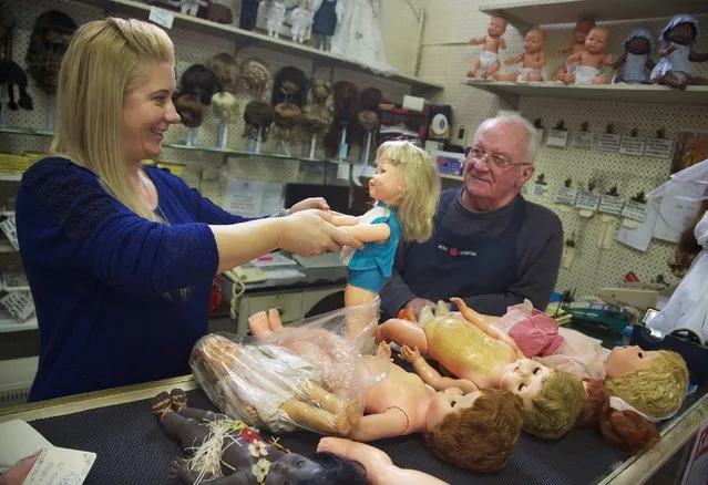 Geoff Chapman (R), “Head Surgeon” and third-generation owner of Sydney's Doll Hospital, is pictured with employee Nadine Kosztka, as they inspect customers dolls that have been brought in for repair, May 20, 2014. (Photo by Jason Reed/Reuters)