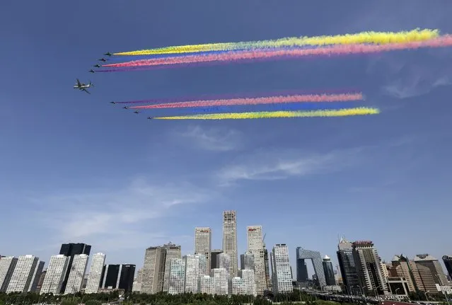 A formation of military airplanes, consists of one KJ-2000 aircraft and eight J-10 fighter jets, flies past the central business area (CBD) of Beijing during the military parade marking the 70th anniversary of the end of World War Two, in Beijing, China, September 3, 2015. (Photo by Reuters/Stringer)