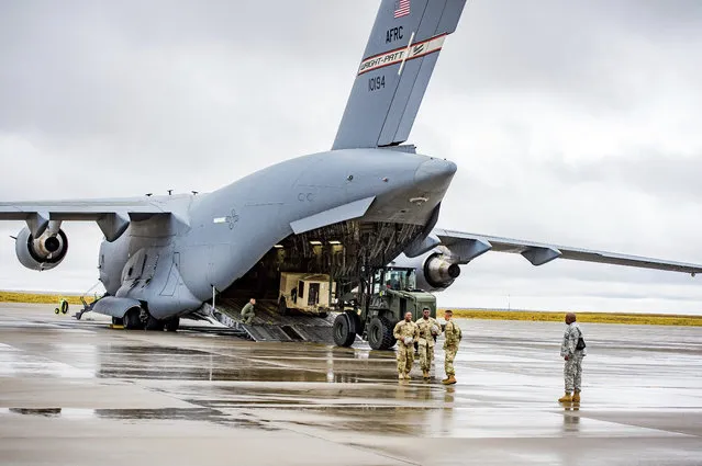 Various supplies and military vehicles are loaded into the C-17 Loadmaster as approximately 150 4th Sustainment Brigade, 4th Infantry Division soldiers were deployed to Puerto Rico and the Virgin Islands to provide sustainment support to Hurricane Maria Relief efforts at Fort Carson ADAC/G on Friday September 29, 2017 in Colorado Springs, Colo. (Photo by Dougal Brownlie/The Gazette via AP Photo)