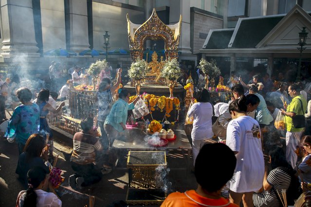 People pray after a religious ceremony at the Erawan shrine, the site of a recent deadly blast, after its was repaired, in central Bangkok, Thailand, September 4, 2015. (Photo by Athit Perawongmetha/Reuters)