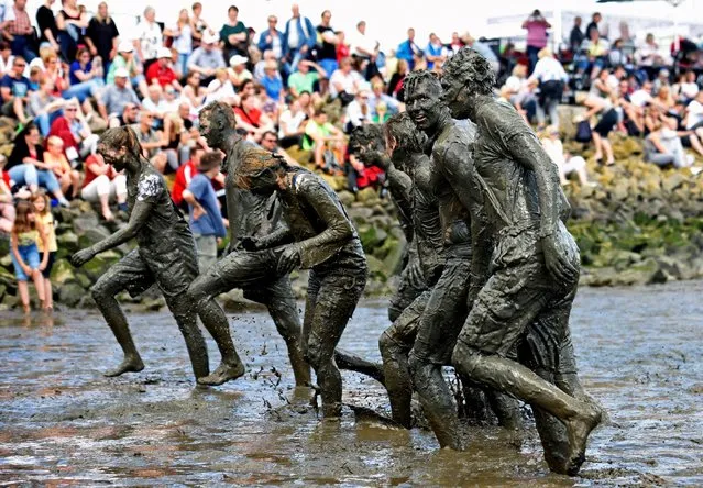 Participants leave the pitch after their match at the so called “Wattoluempiade” (Mud Olympics) in Brunsbuettel at the North Sea, Germany July 30, 2016. (Photo by Fabian Bimmer/Reuters)
