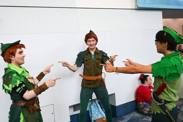 Fans cosplay in Peter Pan costumes during the Walt Disney D23 Expo in Anaheim, California on September 9, 2022 (Photo by Patrick T. Fallon/AFP Photo)