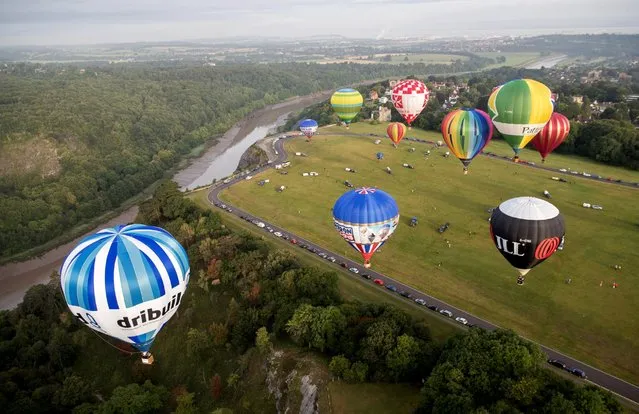 Hot air balloons take to the skies at a preview flight to launch next week's Bristol International Balloon Fiesta, August 5, 2016, in Bristol, England. (Photo by Matt Cardy/Getty Images)