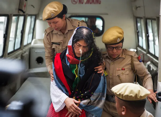 Policewomen escort Indian human rights activist Irom Sharmila as she arrives at a court in the northeastern city of Imphal, India, August 9, 2016. The 44-year-old activist who has been on a hunger strike for nearly 16 years to protest against alleged brutality by India's military, is expected to end her fast today. (Photo by Reuters/Stringer)