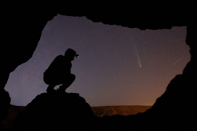 Eduardo Robaina observes the comet C/2023 A3 (Tsuchinshan-ATLAS) from inside a cave in Temisas, on the island of Gran Canaria, Spain, on October 22, 2024. (Photo by Borja Suarez/Reuters)