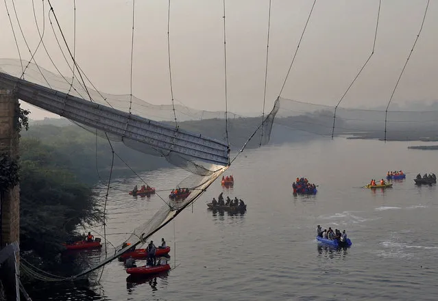 Rescuers search for survivors after a suspension bridge collapsed in Morbi town in the western state of Gujarat, India on October 31, 2022. (Photo by Reuters/Stringer)