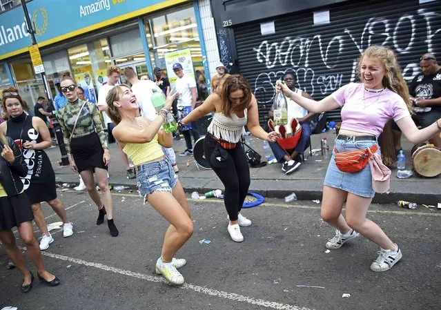 People dance during the Notting Hill Carnival in London, Britain August 29, 2016. (Photo by Neil Hall/Reuters)