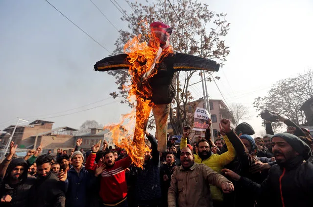 Demonstrators burn an effigy depicting U.S. President Donald Trump during a protest against the U.S. decision to recognize Jerusalem as the capital of Israel, in Srinagar December 8, 2017. (Photo by Danish Ismail/Reuters)
