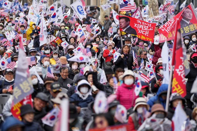 Supporters of impeached South Korean President Yoon Suk Yeol wave national flags and those with images of Yoon during a rally to oppose his impeachment near the Constitutional Court in Seoul, South Korea, Wednesday, April 2, 2025. The letters read “President, comeback immediately”. (Photo by Lee Jin-man/AP Photo)