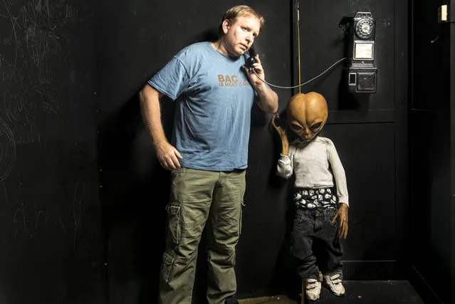 Chris has fun with one of the exhibits. (Photo by Chris Burton/Caters News Agency)