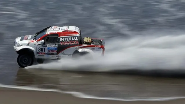 Giniel de Villiers of South Africa and Dirk Von Zitzewitz of Germany race their Toyota on a beach in the 4th stage of the 2013 Dakar Rally from Nazca to Arequipa, Peru. (Photo by Victor R. Caivano/Associated Press)