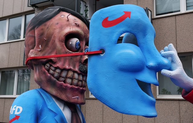 A carnival float depicting a clown lifting a German far-right party Alternative for Germany (AfD) mask from the face of Adolf Hitler is ready for the start of the annual Rose Monday (Rosenmontag) Carnival parade in Duesseldorf, Germany, 12 February 2024. Rose Monday is the traditional highlight of the carnival season in many German cities. (Photo by Christopher Neundorf/EPA/EFE)