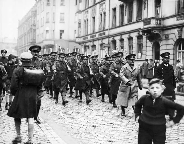The first detachment of British troops arriving in the Saar to police the district's plebiscite in January, in which Saar residents will vote whether to go under French, German or league of nations rule. Troops from other nations also will staff the international police force. A railway porter guiding the first British troops through a street of Saarbrucken, December 19, 1934. (Photo by AP Photo)