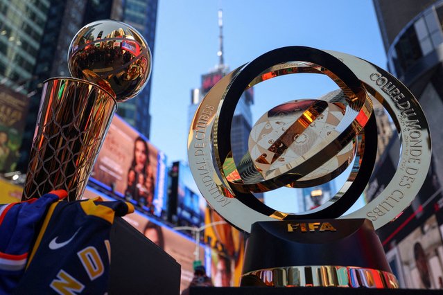 The 2025 NBA Champion Larry O'Brien Trophy and The FIFA Club World Cup 2025 winners trophy are displayed in Times Square ahead of the FIFA tournament featuring 32 teams and 63 matches, spread across 12 stadiums in 11 U.S. cities in June and July, in New York City on May 20, 2025. (Photo by Mike Segar/Reuters)