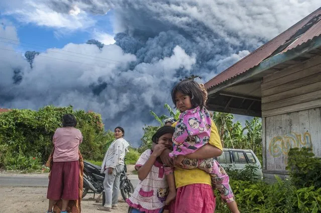 Indonesia's Mount Sinabung erupts, sending a column of volcanic materials as high as 16,000 feet into the sky on August 10, 2020. The volcano, one of two currently erupting in Indonesia, was dormant for four centuries before exploding in 2010, killing two people. Another eruption in 2014 killed 16 people, while seven died in a 2016 eruption. (Photo by Sutanta Aditya/Abaca/Sipa USA via AP Images)