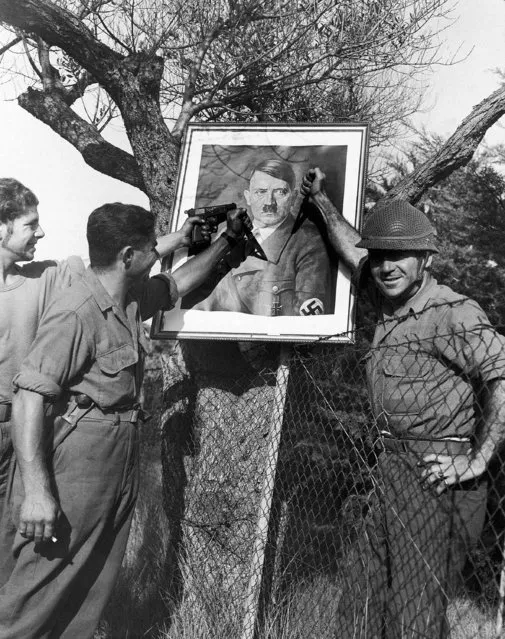 French troops, advancing with Allied forces northward from the coast of southern France, use a picture of Adolf Hitler found in a captured Nazi headquarters to demonstrate what they would like to do to the Madman of Europe, August 24, 1944. (Photo by Sherman Montrose/AP Photo/Acme)