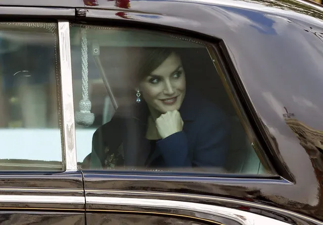 Spanish Queen Letizia (R) smiles as she departs for the Royal Palace, where the royal couple will host a reception for Spanish personalities, after attending the army parade to mark Spain's National Day in Madrid, Spain, 12 October 2015. Some 3,400 troops and Civil Guard officers, 48 vehicles and 53 planes took part in the parade. (Photo by Javier Lizon/EPA)
