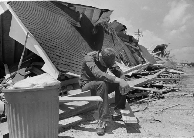 Sixteen-year-old Glenn Lacombe sits with his head bowed after returning to the remains of his home in Buras, La., August 22, 1969, four days after Hurricane Camille hit the Gulf Coast. Authorities prevented residents from returning to their homes for several days after the storm. (Photo by Jack Thornell/AP Photo)