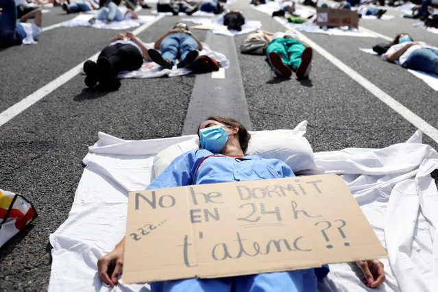 Internal medical residents (MIR) take part in a protest to demand compensation improvements in their salary within their working hours after the coronavirus disease (COVID-19) emergency, in Barcelona, Spain on September 29, 2020. The banner reads “I have not slept in 24 hours, do I attend you?”. (Photo by Nacho Doce/Reuters)