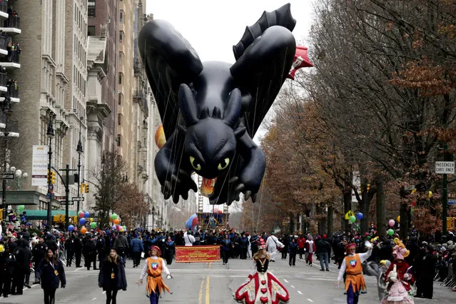 A balloon in the shape of a character in the children's cartoon movie “How To Train Your Dragon” cruises along Central Park West during the Macy's Thanksgiving Day Parade, Thursday, November 27, 2014, in New York. (Photo by Julio Cortez/AP Photo)