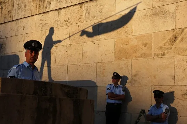 Protesters take part in an anti-government rally organised by the  “Resign!” movement, ouside the parliament in Athens, Greece, 15 June 2016. Thousands of people took part in a protest movement that organizers have named “Resign!' outside the parliament at central Syntagma Square. The 'Resign!” movement is the initiative of certain individuals who call on the government to resign because of failed policies and measures that drive the country to poverty. (Photo by Orestis Panagiotou/EPA)