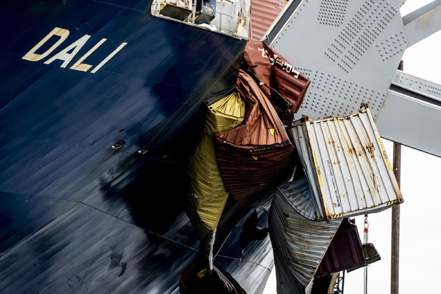 A section of the Dali, a massive container ship from Singapore, is seen as the vessel still sits amid the wreckage and collapse of the Francis Scott Key Bridge in the Baltimore port, Monday, April 1, 2024. (Photo by Kaitlin Newman/The Baltimore Banner via AP) Photo