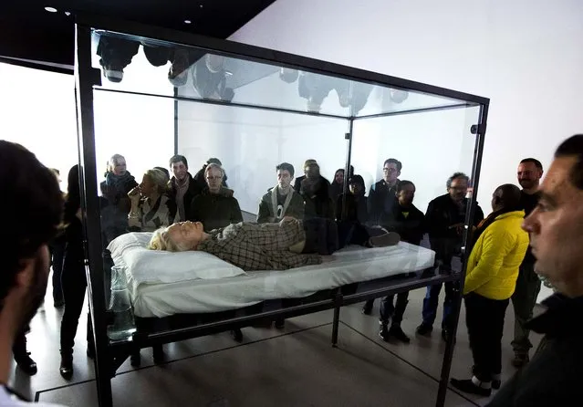 Actress Tilda Swinton performs the art of sleeping in her one-person piece called “The Maybe”, in New York's Museum of Modern Art, on March 25, 2013. In “The Maybe”, first performed at the Serpentine Gallery in London in 1995, Swinton lies sleeping in a glass box for the day. The exhibit will move locations within the museum every time Swinton performs. (Photo by Richard Drew/Associated Press)