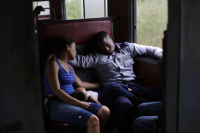In this March 23, 2015 photo, an off-duty police officer travels with his family to Santa Clara during a long trip through the province of Holguin in Cuba. From east to the west, trains offer a fine-grained, slow-moving view of Cuba that few foreigners ever see. (Photo by Ramon Espinosa/AP Photo)