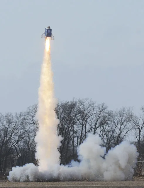 Members of the Michiana Rocketry launch a 10-foot, 450 pound porta-potty, mounted on rocket motors, Saturday, December 6, 2014, from a field in Three Oaks, Mich. (Photo by Don Campbell/AP Photo/The Herald-Palladium)