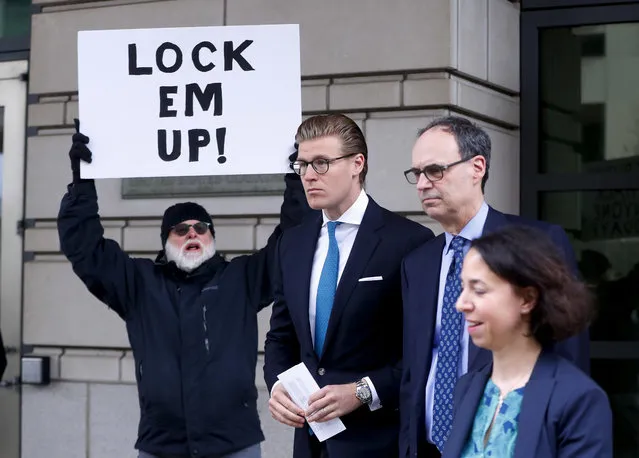 Alex van der Zwaan leaves Federal District Court in Washington, Tuesday, April 3, 2018. Holding the sign up is Bill Christeson from the Washington area. A federal judge sentenced Alex van der Zwaan to 30 days in prison. (Photo by Pablo Martinez Monsivais/AP Photo)
