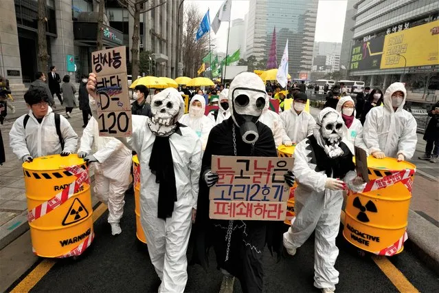 Environmental activists march during a rally marking the 12th anniversary of Fukushima nuclear disaster caused by the March 11 earthquake and tsunami in Japan, in Seoul, South Korea, Thursday, March 9, 2023. They denounced Japan's planned release of treated radioactive wastewater into the sea. (Photo by Ahn Young-joon/AP Photo)