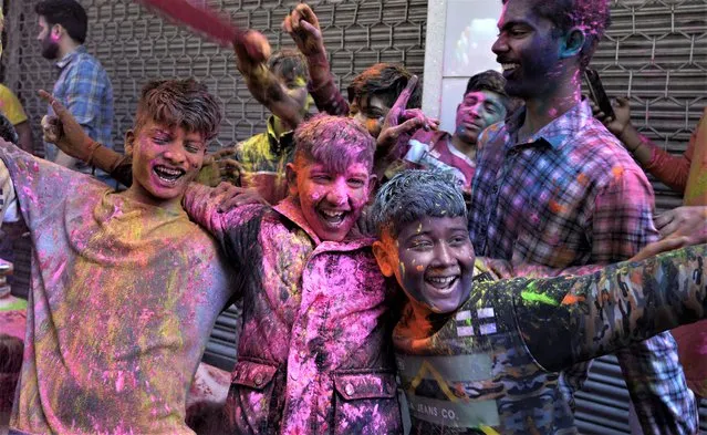 Children put colors on each other as they celebrate Holi, the Hindu festival of colors, in Jammu, India, Tuesday, March 7, 2023. (Photo by Channi Anand/AP Photo)