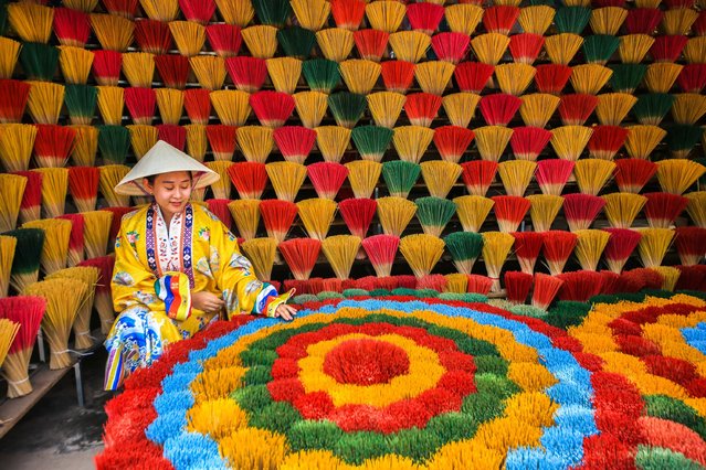A view of colorful incenses, traditionally produced at the Thuy Xuan Incense-making Village, in the central province of Thua Thien Hue, Vietnam on July 06, 2025. The village has been preserving the tradition of incense making for over 700 years. Once producing incense for royal palaces and local communities, the village has now become a popular destination for both domestic and international visitors. The incense sticks, made from natural ingredients such as agarwood, cinnamon, clove, and pine resin, stand out for their pure aromas free from chemical additives. After the bamboo sticks are sun-dried, a natural mixture is carefully applied, creating incense used in both religious rituals and daily life. The colorful bundles of incense sticks left to dry in the villagefeaturing dominant shades of green, red, purple, and yellowresemble a vibrant flower garden. Tourists visiting the village can observe the entire production process, from drying the bamboo sticks in the sun to applying the mixture, and even try making their own incense if they wish. (Photo by Ummu Nisan Kandilcioglu/Anadolu via Getty Images)