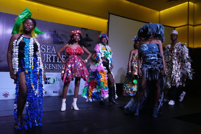 Models wearing an outfit made from recycled plastic and Newspapers walk the runway during a '“trashion show” in Lagos, Nigeria, Wednesday, October 22, 2025. (Photo by Sunday Alamba/AP Photo)