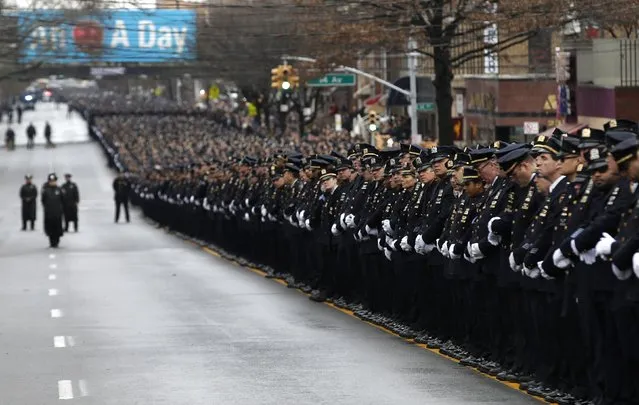 Police stand in formation down 65th street as they listen to the funeral service for New York Police Department officer Wenjian Liu in the Brooklyn borough of New York January 4, 2015. (Photo by Mike Segar/Reuters)