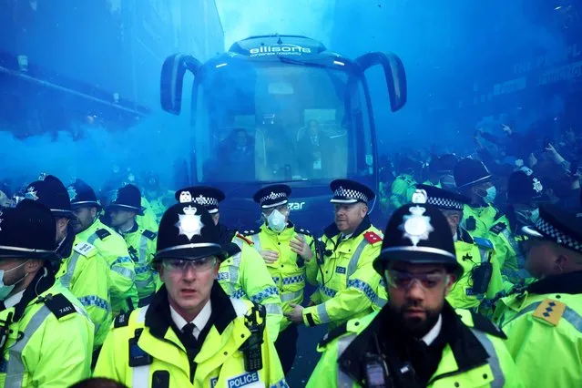 Police officers escort the Everton team bus outside the Goodison Park stadium in Liverpool, before the match against Newcastle United on April 27, 2023. (Photo by Carl Recine/Reuters)