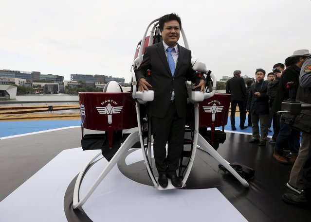 KuangChi Science Ltd Chairman and Executive Director Liu Ruopeng poses with a Martin Jetpack, made by New Zealand-based Martin Aircraft, during a demonstration at a water park in Shenzhen, China December 6, 2015. (Photo by Bobby Yip/Reuters)