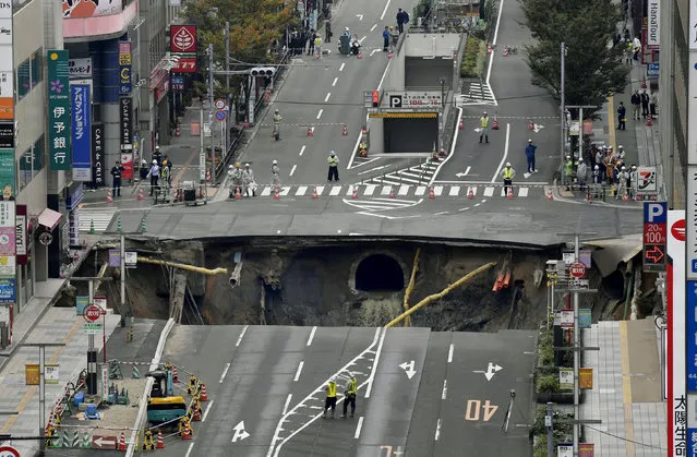 A huge sinkhole is seen at an intersection near Hakata station in Fukuoka, Japan, November 8, 2016 in this photo taken by Kyodo. (Photo by Reuters/Kyodo News)