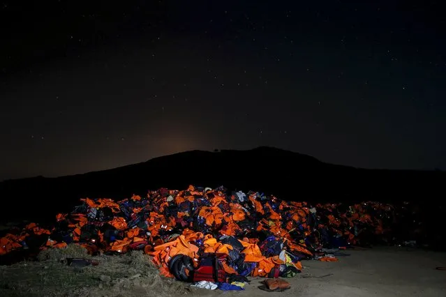 A long exposure photo shows thousands of lifejackets left by migrants and refugees, piled up at a garbage dump site on the Greek island of Lesbos, November 9, 2015. (Photo by Alkis Konstantinidis/Reuters)