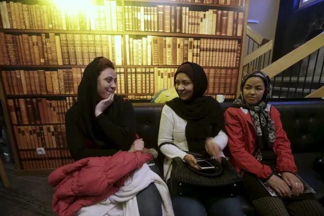 Refugee women sit in the lobby of their camp at a hotel touted as the world's most northerly ski resort in Riksgransen, Sweden, December 15, 2015. (Photo by Ints Kalnins/Reuters)