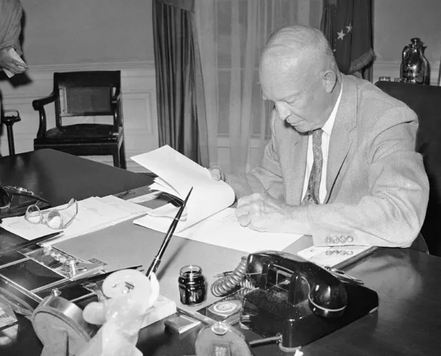 President Dwight D. Eisenhower signs the Alaska statehood bill, July 7, 1958, in Washington. This paves the way for the territory's admission to the Union later this year. (Photo by Charles Gorry/AP Photo)
